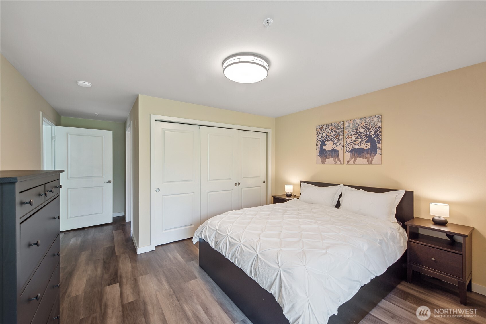 108 5th Avenue South, Unit 506 Seattle, WA 98104 - Photo 12 of 17 a bedroom with a bed and wooden floor