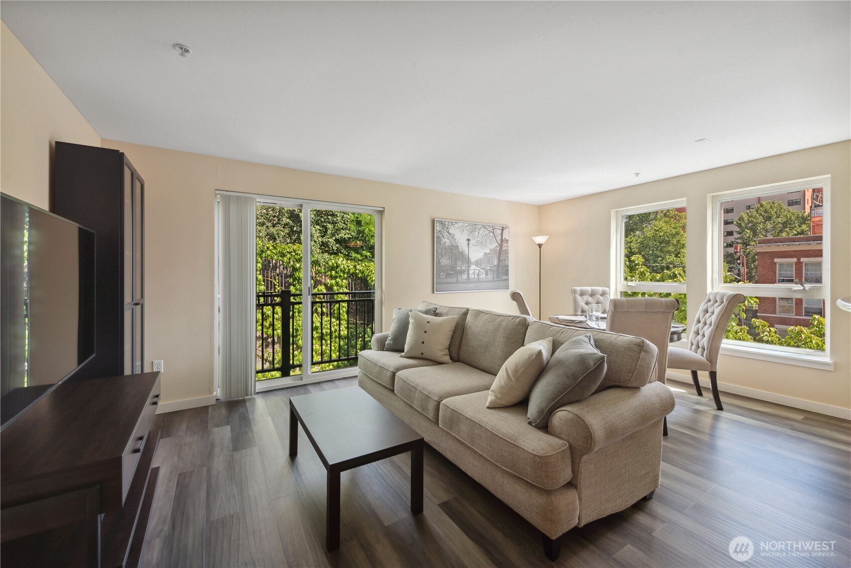 108 5th Avenue South, Unit 506 Seattle, WA 98104 - Photo 3 of 17 a living room with furniture and a flat screen tv