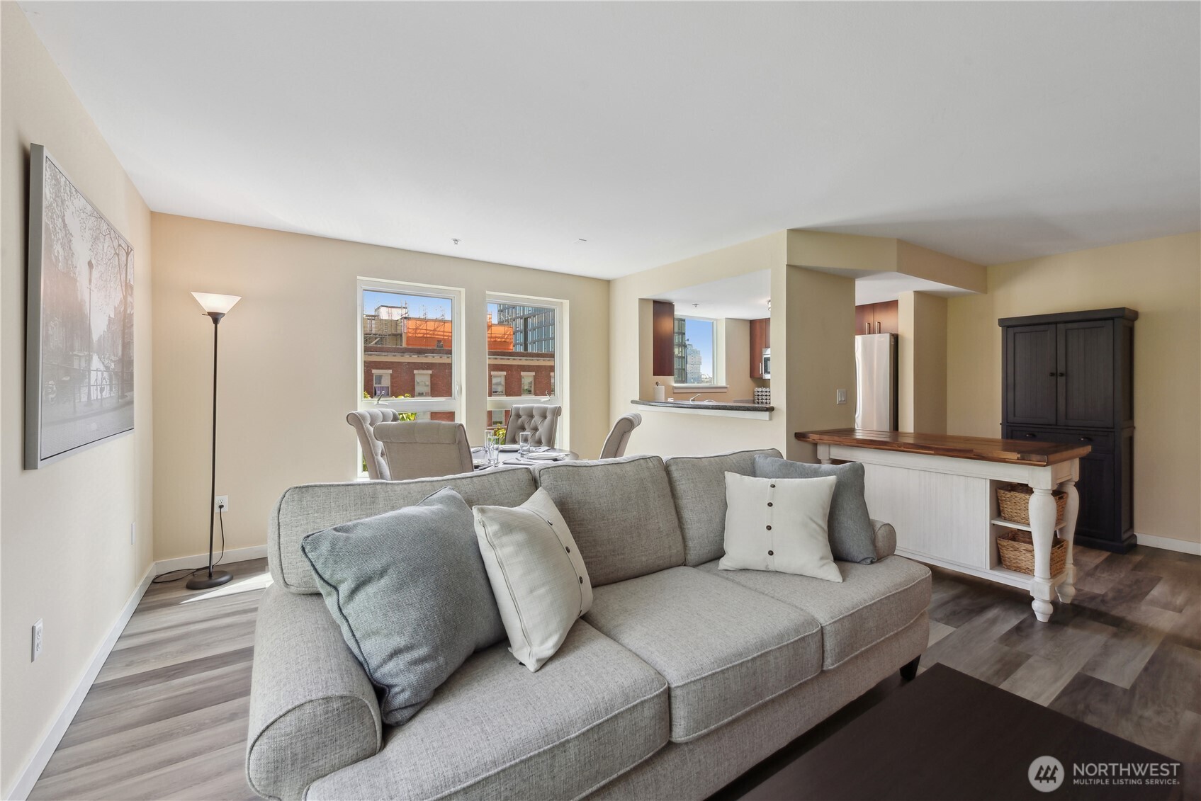 108 5th Avenue South, Unit 506 Seattle, WA 98104 - Photo 5 of 17 a living room with furniture and a flat screen tv
