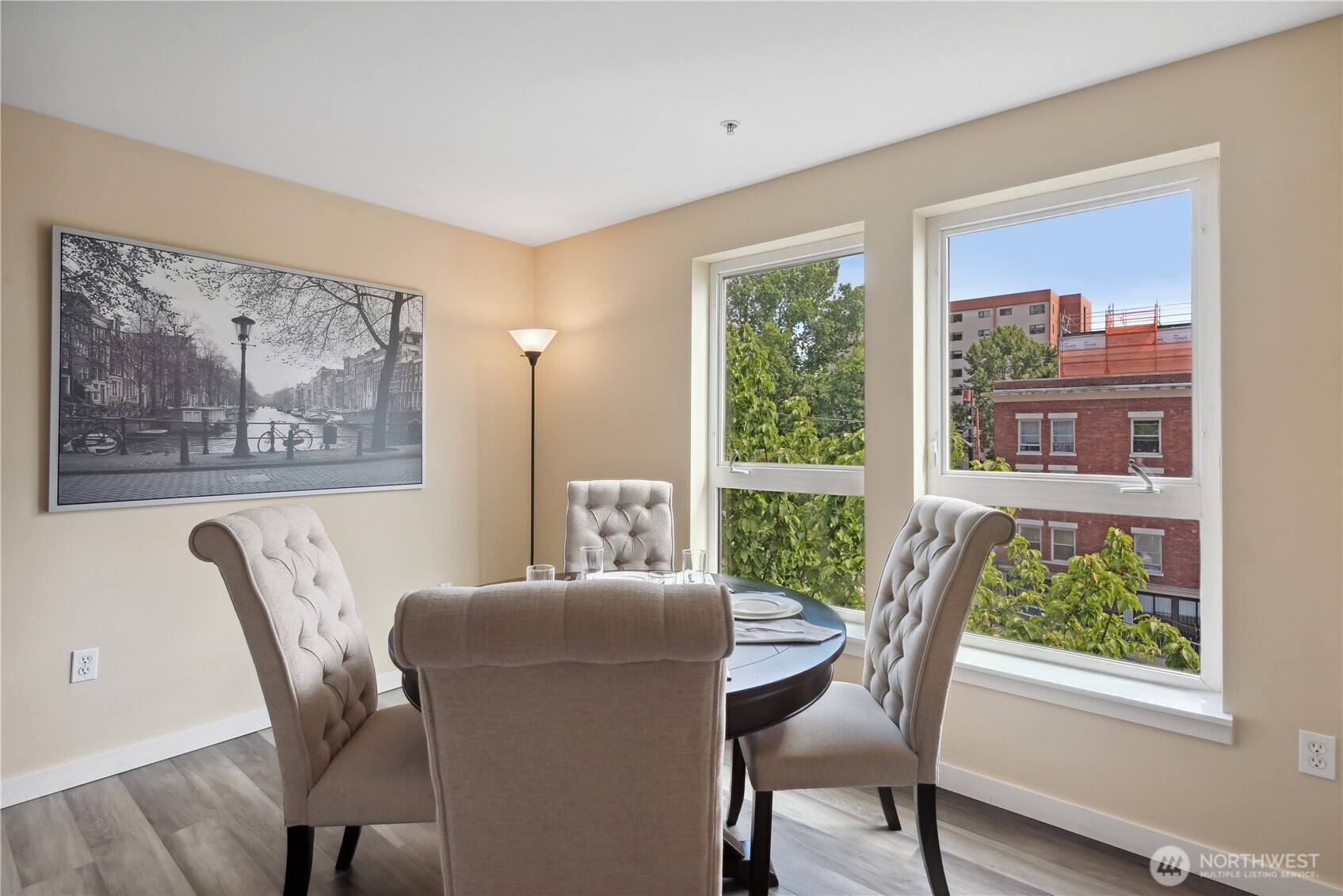 108 5th Avenue South, Unit 506 Seattle, WA 98104 - Photo 6 of 17 a view of a dining room with furniture a rug and wooden floor