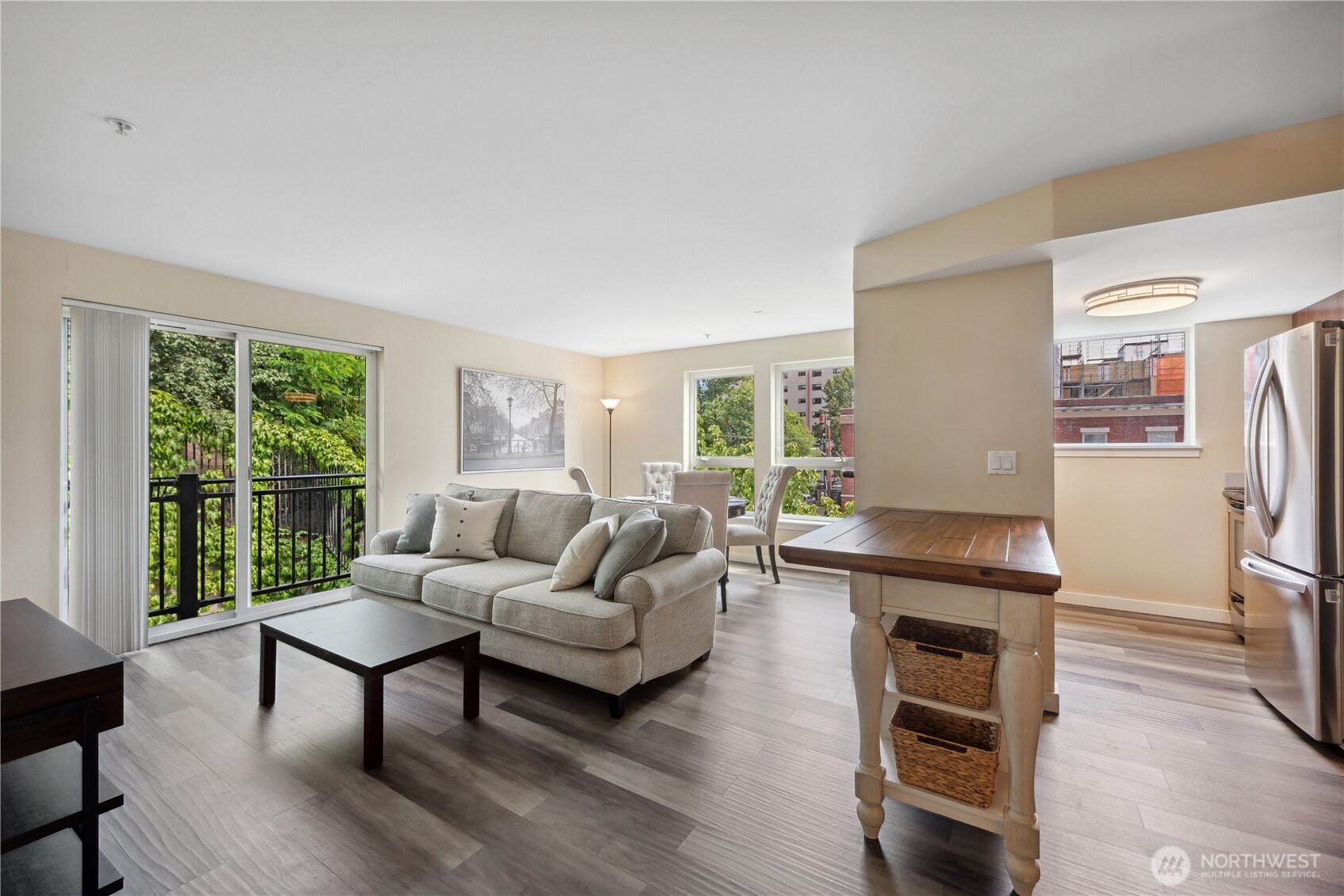 108 5th Avenue South, Unit 506 Seattle, WA 98104 - Photo 7 of 17 a living room with furniture and a large window