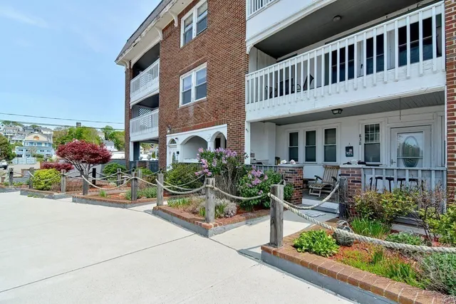 a view of a house with sitting area and potted plants