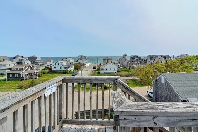 a view of a balcony with two chairs and a yard