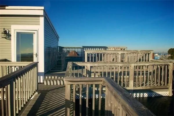 a view of a balcony with wooden floor