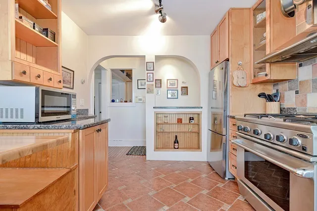 a kitchen with stainless steel appliances granite countertop a stove and a refrigerator