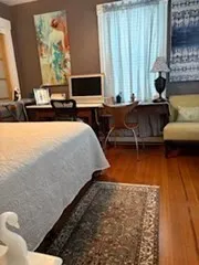 a bedroom with natural light and a bed