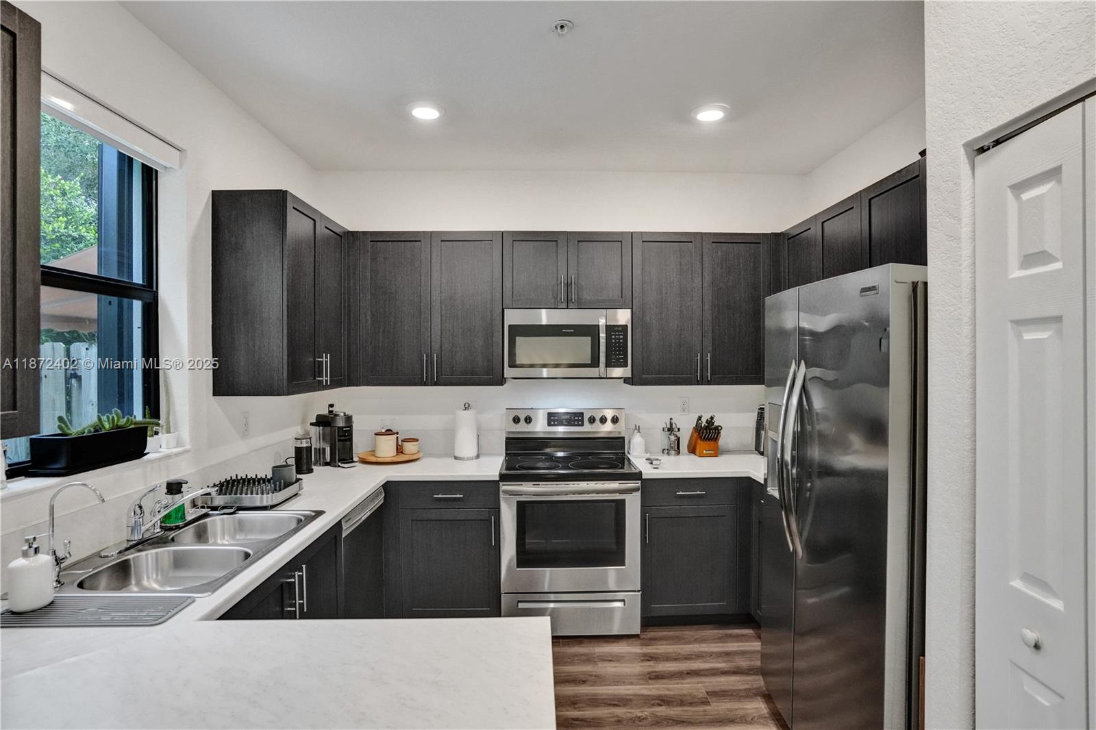 136 Southwest 185th Way Pembroke Pines, FL 33029 - Photo 12 of 48 a kitchen with stainless steel appliances granite countertop a refrigerator stove and sink