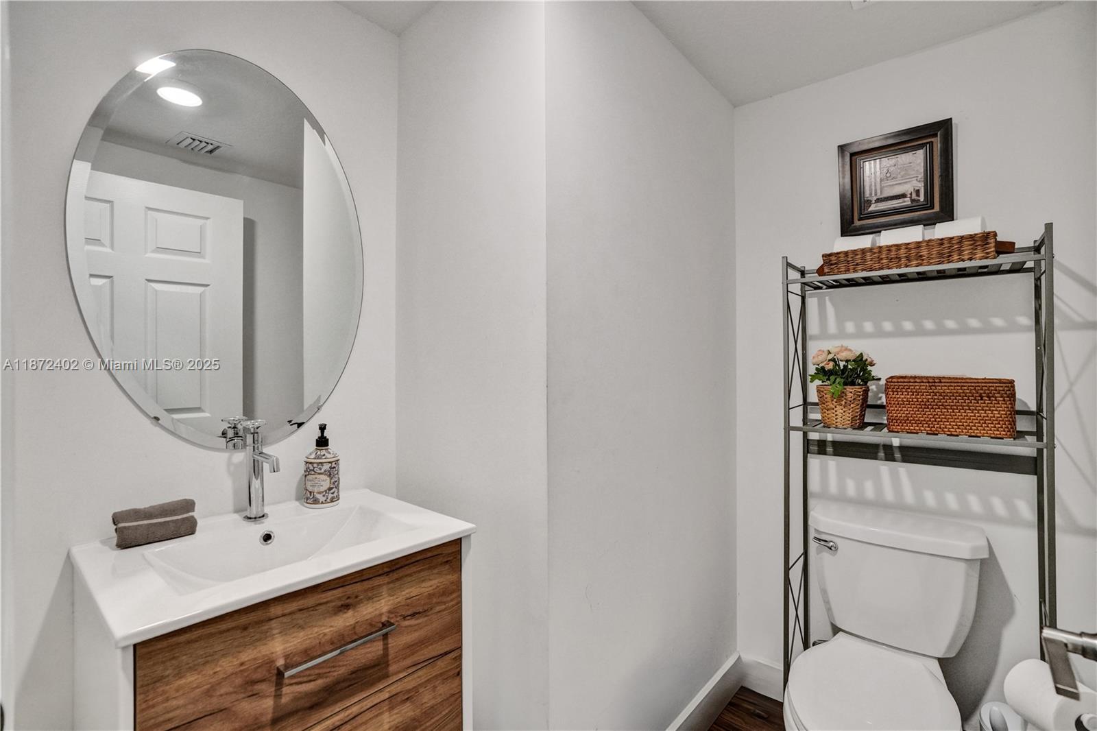 136 Southwest 185th Way Pembroke Pines, FL 33029 - Photo 17 of 48 a bathroom with a toilet a sink and mirror
