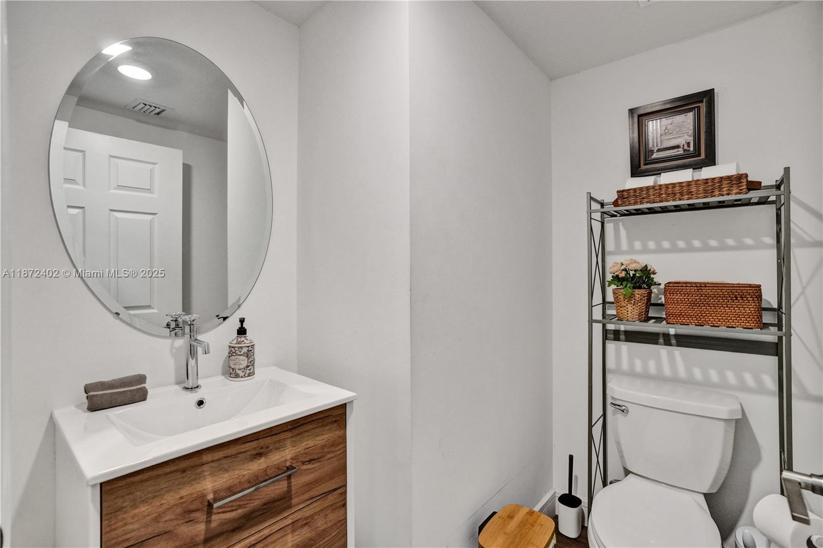 136 Southwest 185th Way Pembroke Pines, FL 33029 - Photo 18 of 48 a bathroom with a toilet a sink and mirror