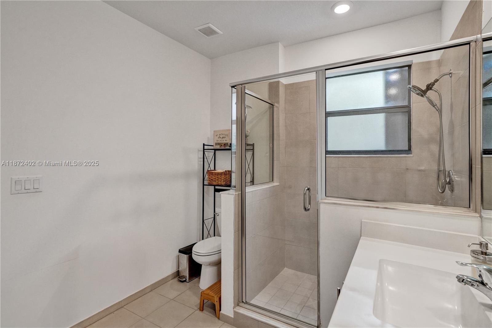 136 Southwest 185th Way Pembroke Pines, FL 33029 - Photo 27 of 48 a bathroom with a glass shower door