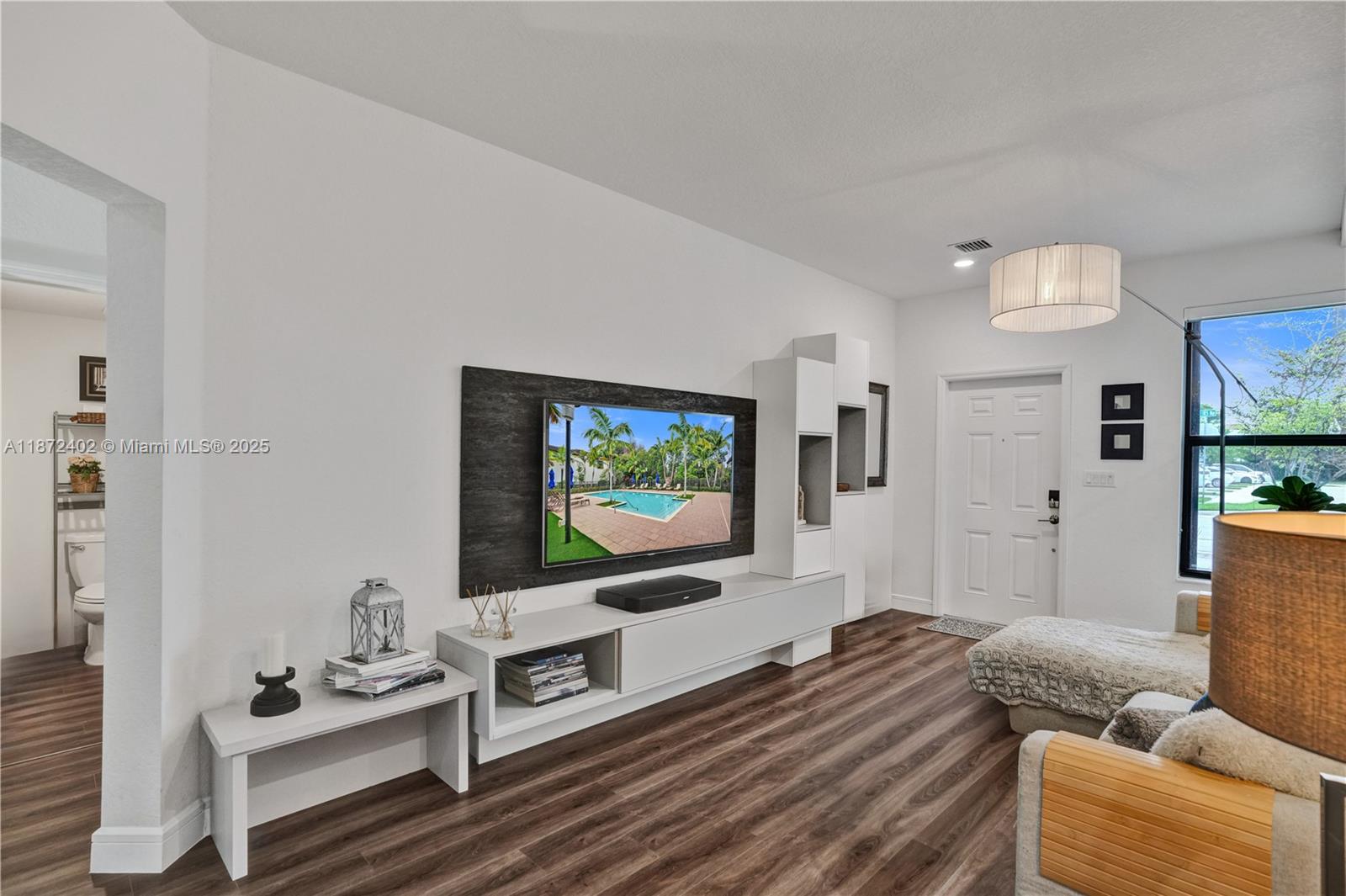 136 Southwest 185th Way Pembroke Pines, FL 33029 - Photo 3 of 48 a living room with furniture and a flat screen tv