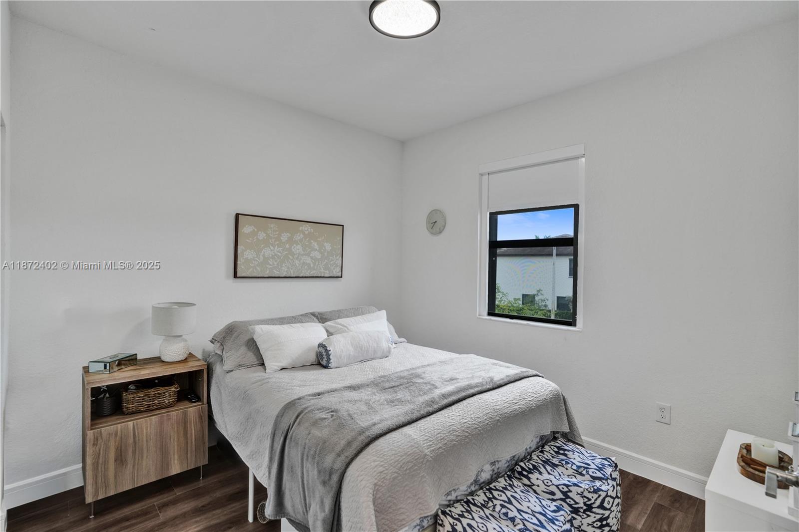 136 Southwest 185th Way Pembroke Pines, FL 33029 - Photo 33 of 48 a bedroom with a bed and a lamp