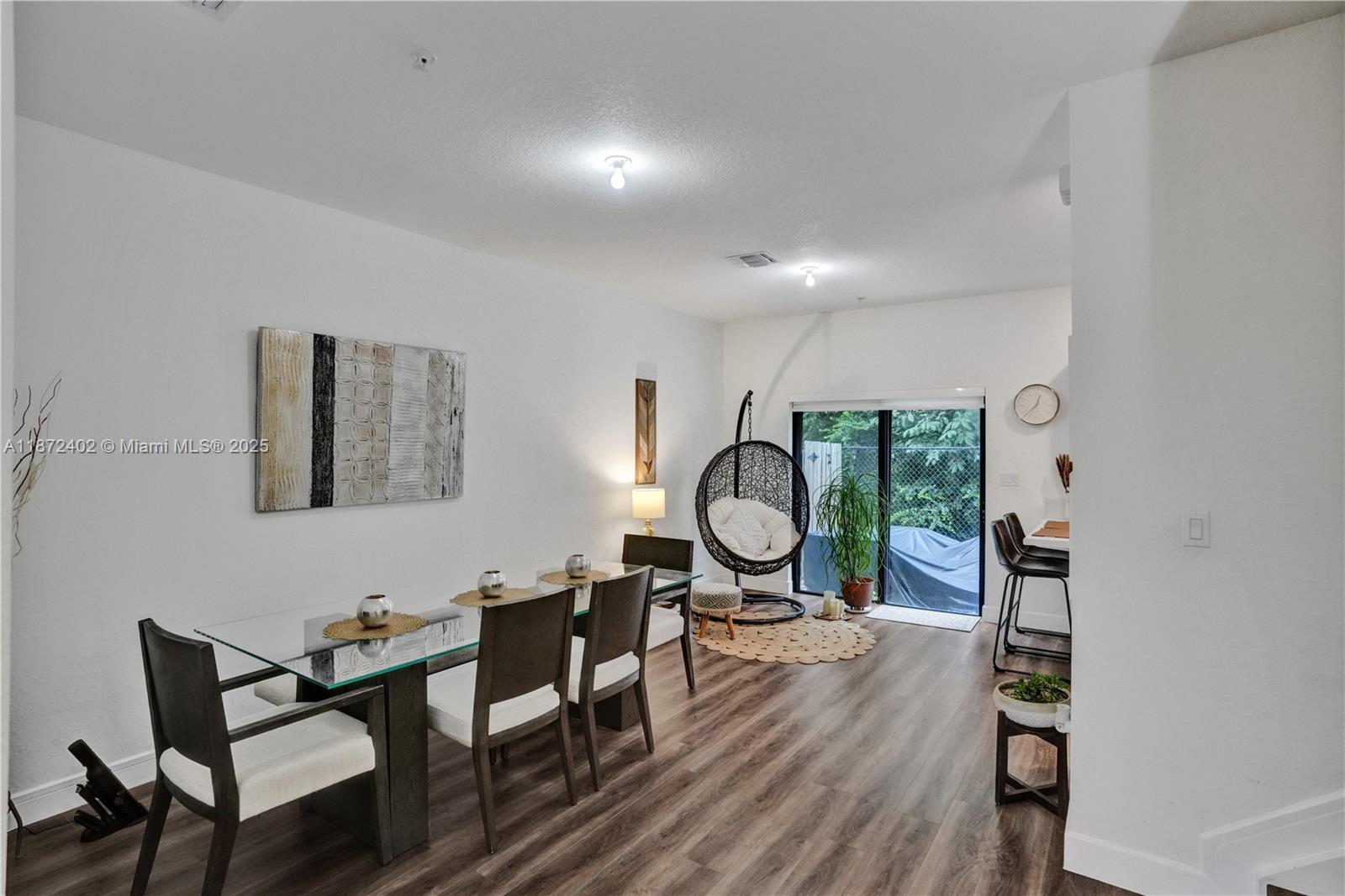 136 Southwest 185th Way Pembroke Pines, FL 33029 - Photo 8 of 48 a view of dining room and livingroom with furniture wooden floor mirror and window
