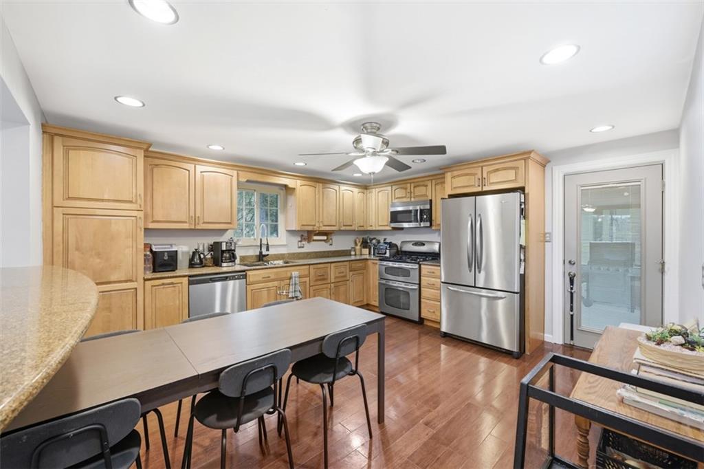 2386 Crestview Road Pittsburgh, PA 15216 - Photo 12 of 48 a kitchen with stainless steel appliances a refrigerator a stove a sink dishwasher and white cabinets with wooden floor