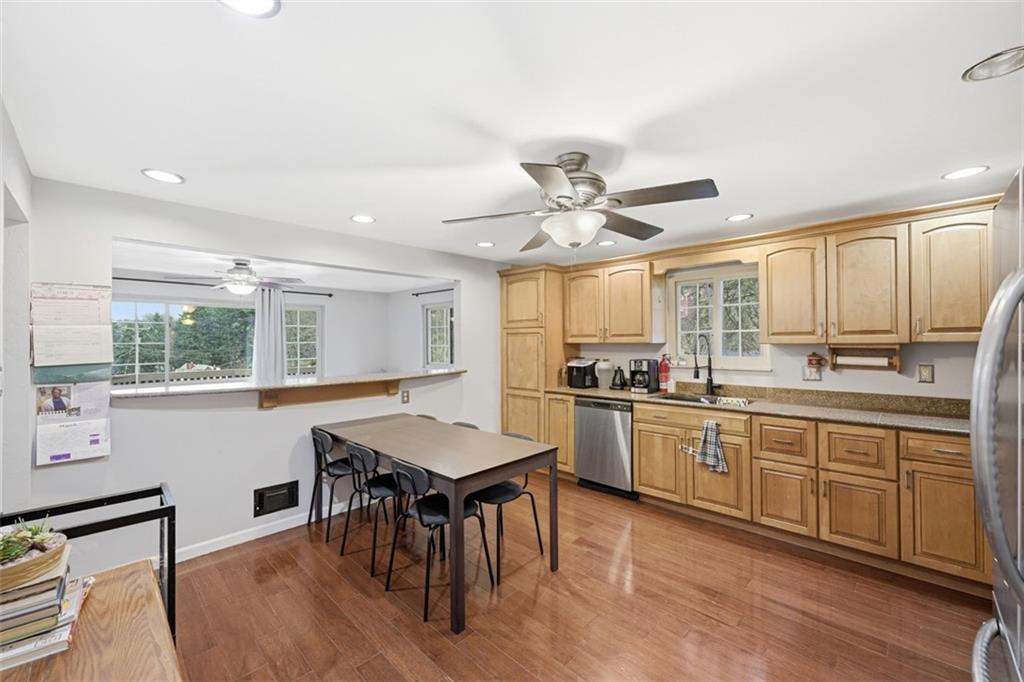 2386 Crestview Road Pittsburgh, PA 15216 - Photo 13 of 48 a kitchen with stainless steel appliances granite countertop a stove a sink dishwasher and a refrigerator with wooden floor