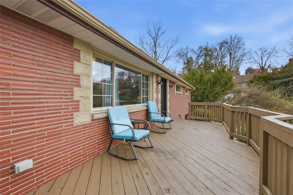 2386 Crestview Road Pittsburgh, PA 15216 - Photo 4 of 48 a view of a roof deck with table and chairs and wooden floor