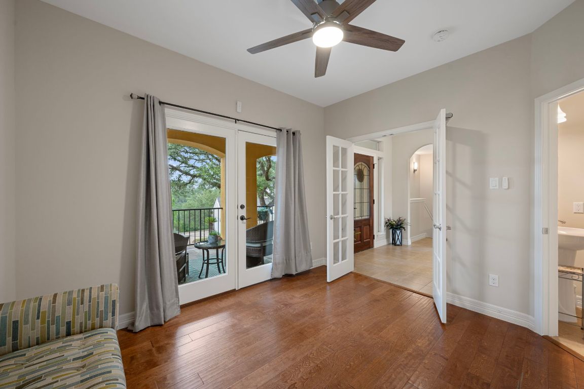 5715 Misty Hill Cove Austin, TX 78759 - Photo 12 of 40 an empty room with wooden floor and a ceiling fan