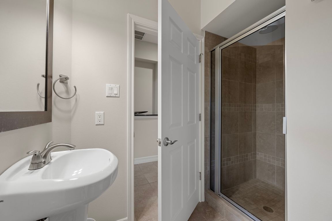 5715 Misty Hill Cove Austin, TX 78759 - Photo 13 of 40 a bathroom with a sink and shower
