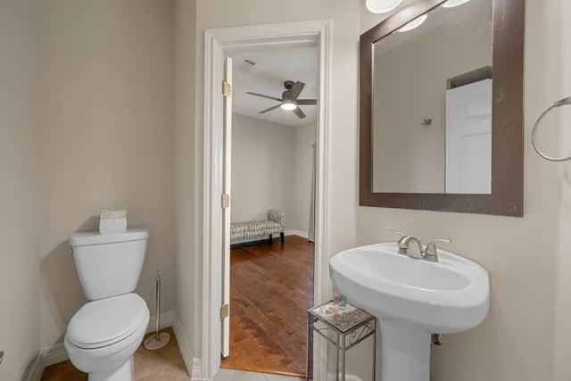 a bathroom with a toilet sink and a mirror