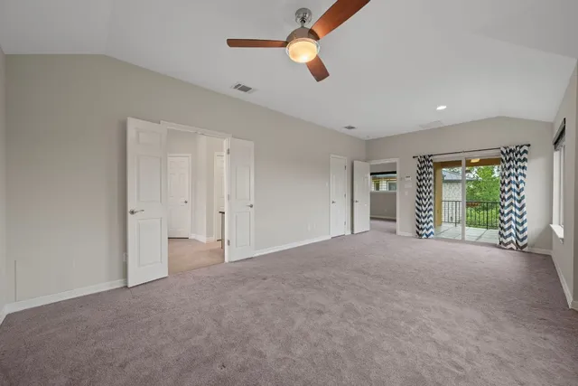 a view of a livingroom with an empty space and a ceiling fan