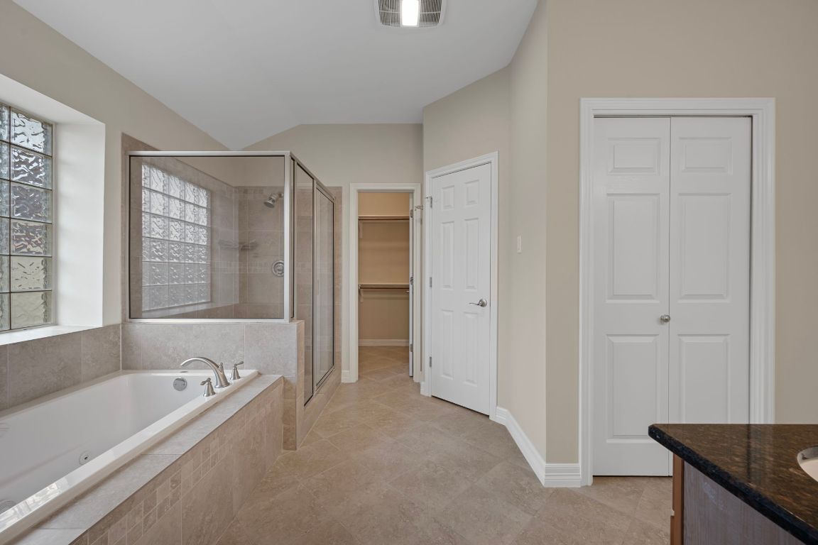 5715 Misty Hill Cove Austin, TX 78759 - Photo 22 of 40 a bathroom with a granite countertop tub sink and mirror