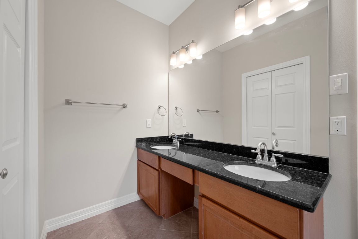 5715 Misty Hill Cove Austin, TX 78759 - Photo 23 of 40 a sink and a mirror