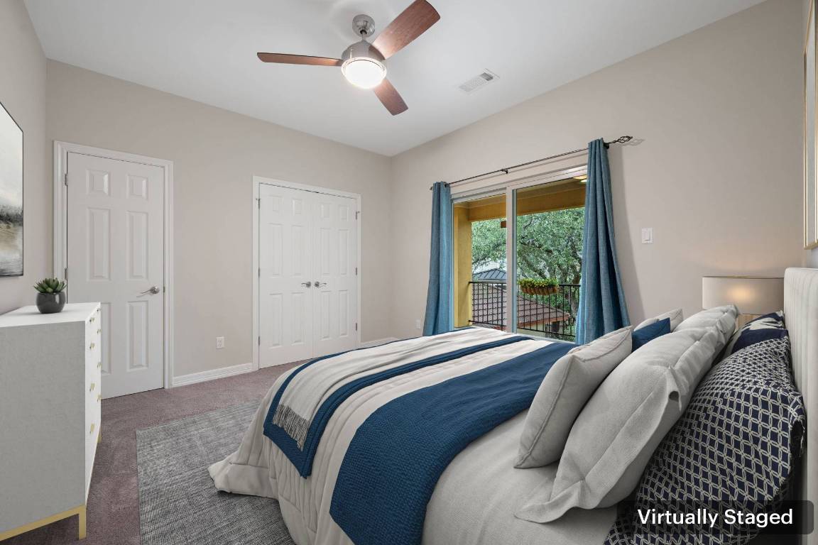 5715 Misty Hill Cove Austin, TX 78759 - Photo 25 of 40 a bedroom with a large bed and a chandelier