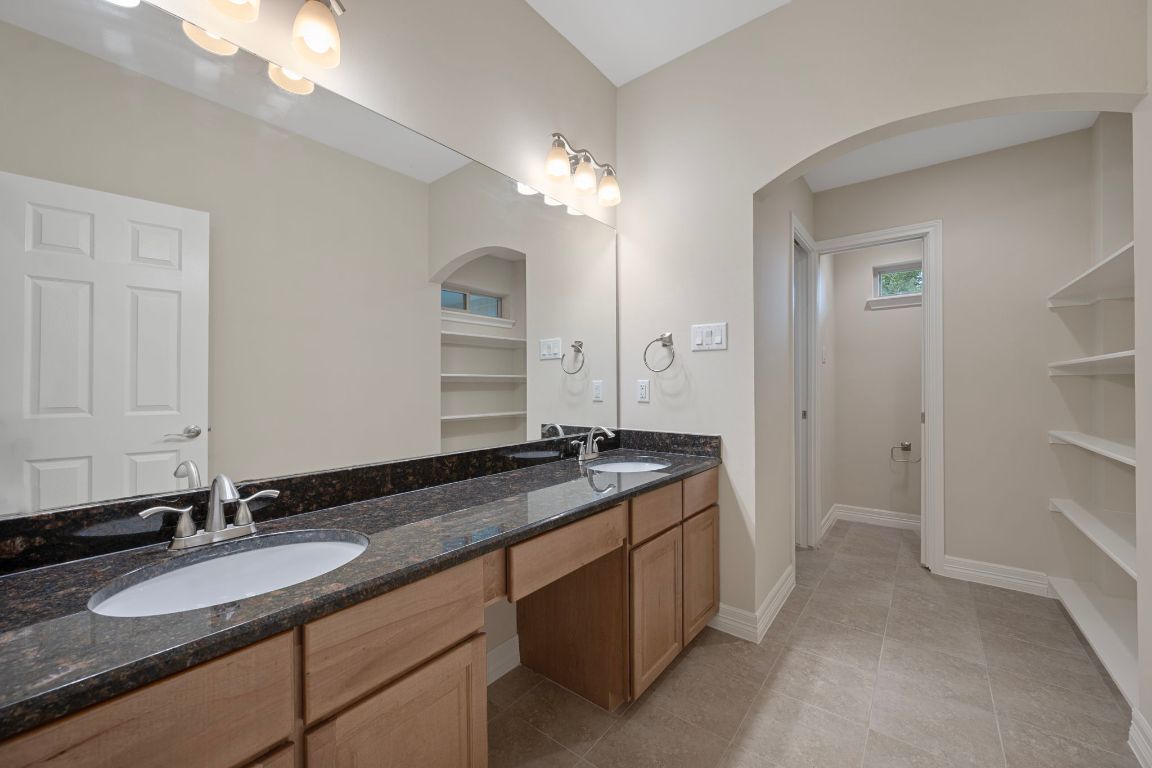 5715 Misty Hill Cove Austin, TX 78759 - Photo 27 of 40 a bathroom with a granite countertop sink double and mirror