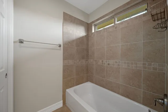 a bathroom with a bathtub and shower