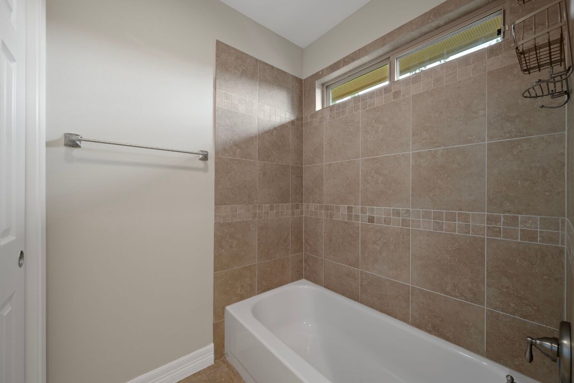 5715 Misty Hill Cove Austin, TX 78759 - Photo 28 of 40 a bathroom with a bathtub and shower