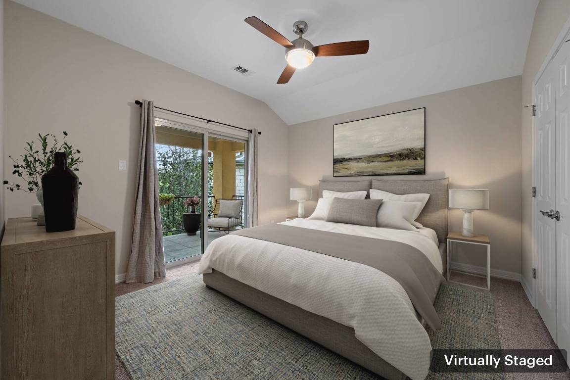 5715 Misty Hill Cove Austin, TX 78759 - Photo 29 of 40 a spacious bedroom with a bed and a chandelier