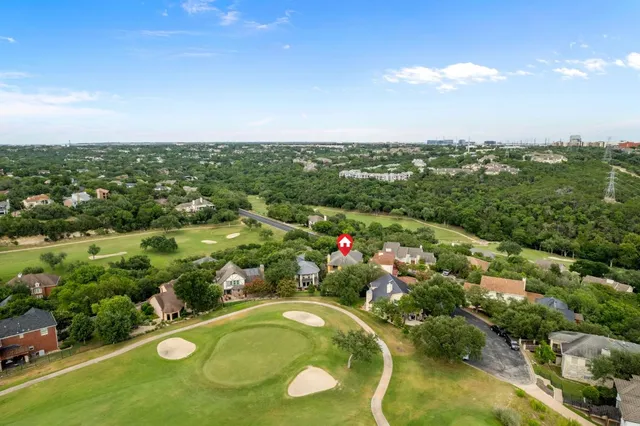 an aerial view of a residential houses with city view