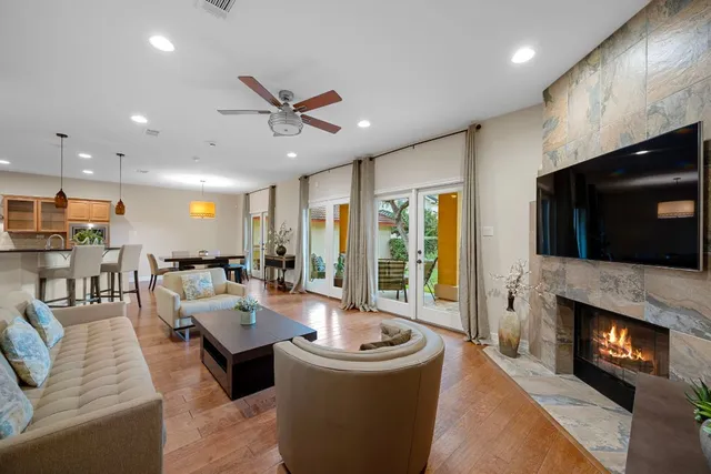a living room with furniture a flat screen tv and a fireplace