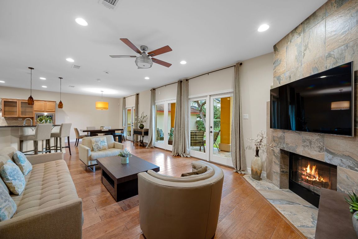 5715 Misty Hill Cove Austin, TX 78759 - Photo 6 of 40 a living room with furniture a flat screen tv and a fireplace