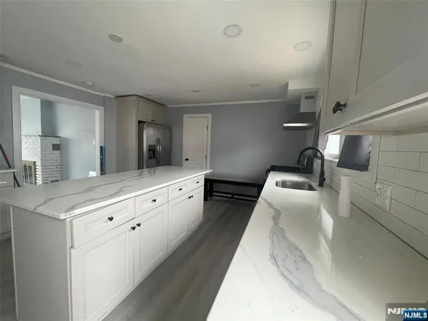 a kitchen with sink stove and cabinets