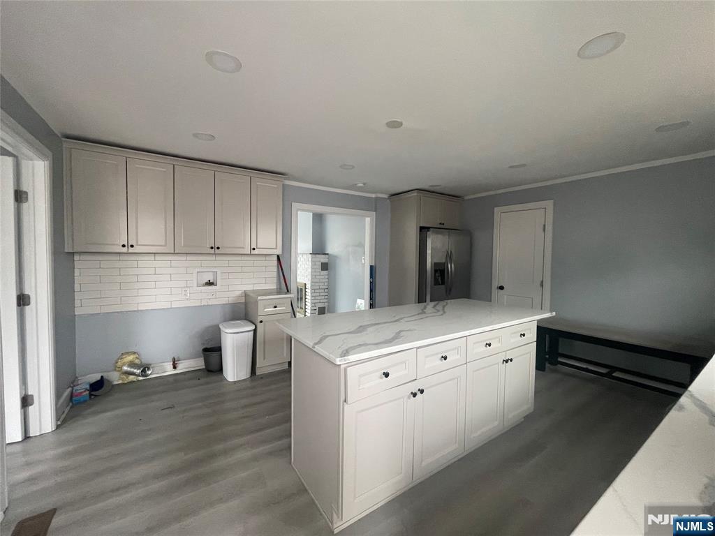 35 Chestnut Street, Unit 1F Wallington, NJ 07057 - Photo 5 of 9 a kitchen with granite countertop white cabinets and white appliances
