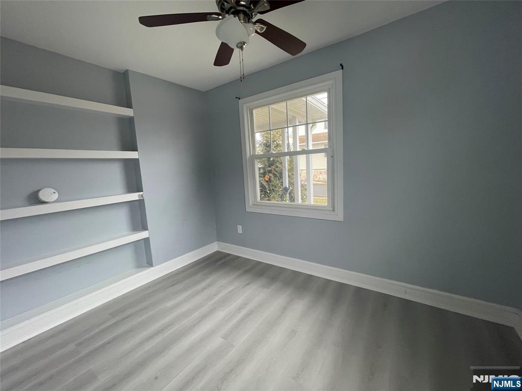 35 Chestnut Street, Unit 1F Wallington, NJ 07057 - Photo 9 of 9 a view of an empty room with a window and a ceiling fan