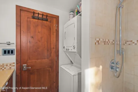 a bathroom with a shower and a sink