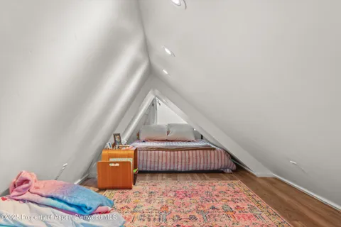 a view of an empty room and wooden floor