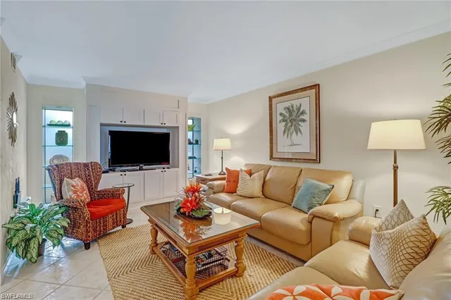 a living room with furniture a rug and a table