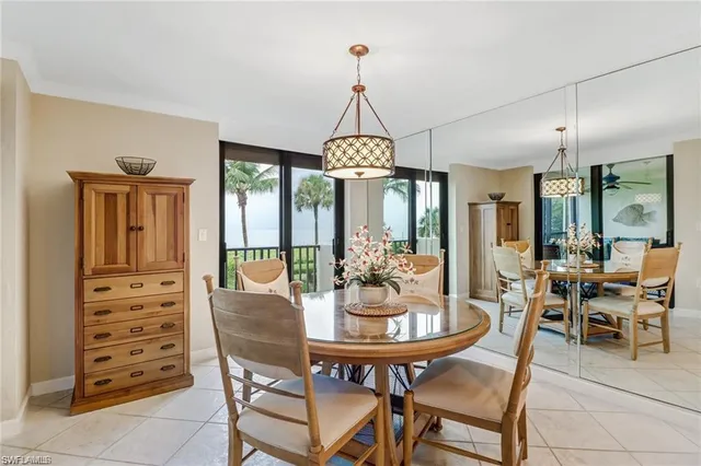 a kitchen with a refrigerator a stove cabinets and living room view