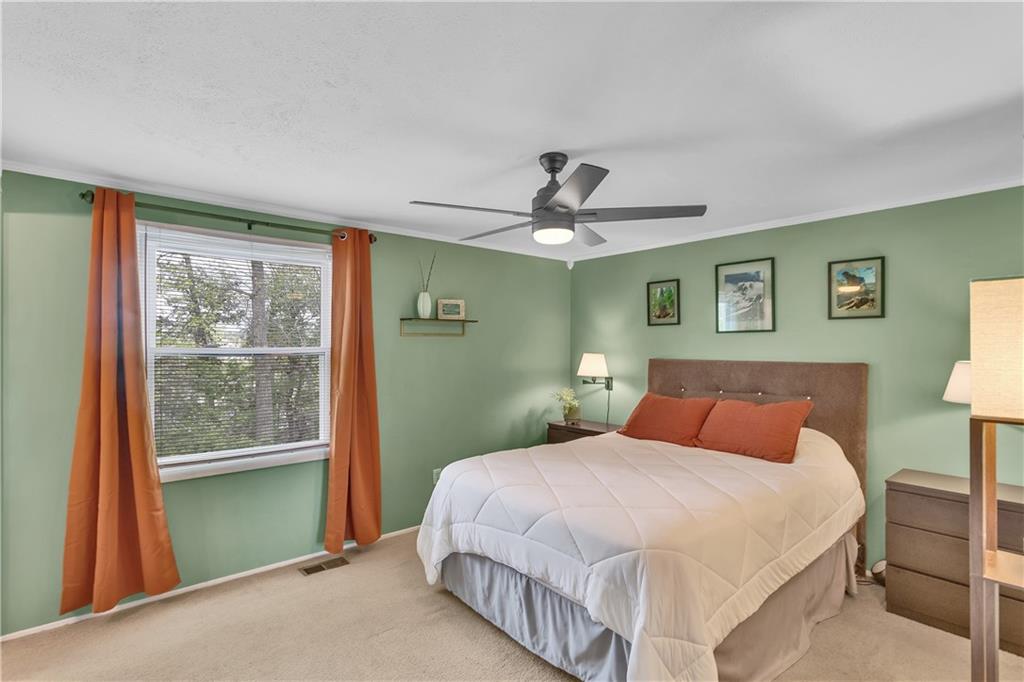 645 Blue Ridge Road Pittsburgh, PA 15239 - Photo 12 of 27 a bedroom with a large bed and a chandelier