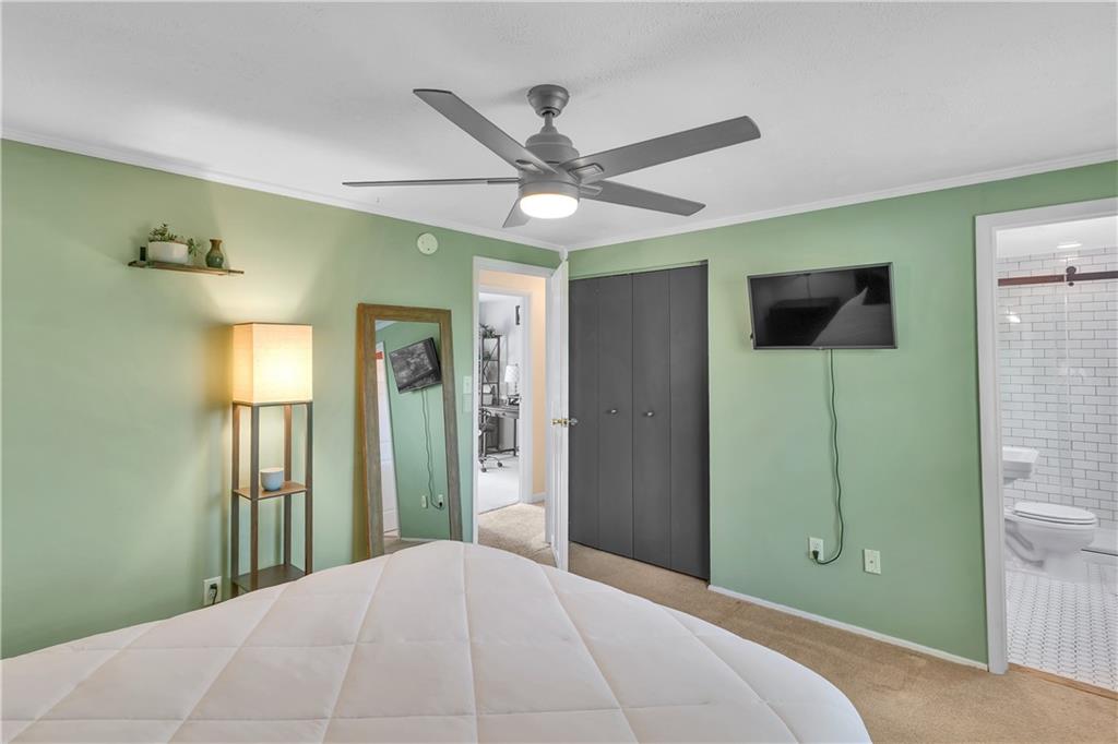 645 Blue Ridge Road Pittsburgh, PA 15239 - Photo 13 of 27 a bedroom with a bed and a chandelier