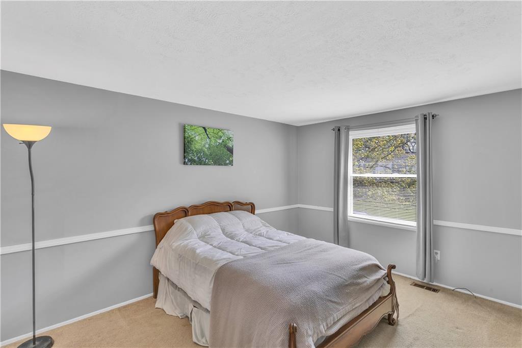 645 Blue Ridge Road Pittsburgh, PA 15239 - Photo 16 of 27 a bedroom with a bed and a window