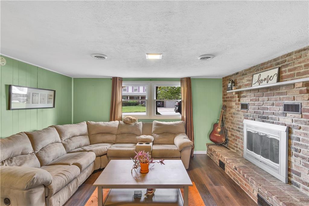 645 Blue Ridge Road Pittsburgh, PA 15239 - Photo 17 of 27 a living room with furniture and a fireplace
