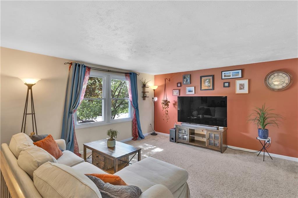 645 Blue Ridge Road Pittsburgh, PA 15239 - Photo 2 of 27 a living room with furniture a window and a flat screen tv