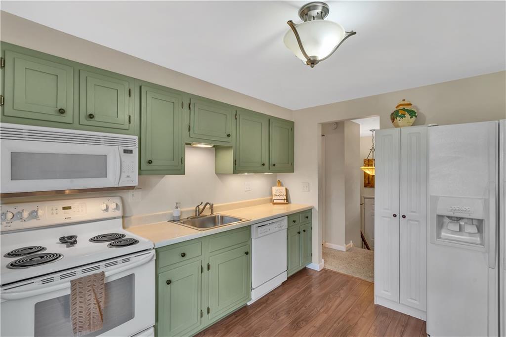 645 Blue Ridge Road Pittsburgh, PA 15239 - Photo 6 of 27 a kitchen with cabinets a stove and a refrigerator