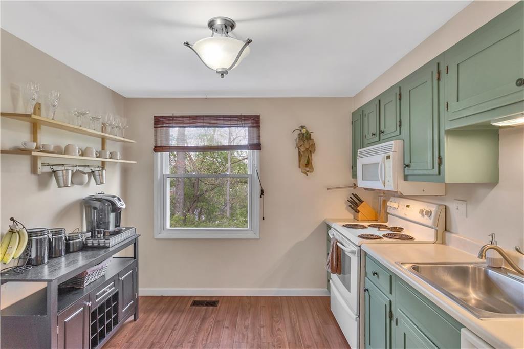 645 Blue Ridge Road Pittsburgh, PA 15239 - Photo 7 of 27 a kitchen with stainless steel appliances granite countertop a sink stove and cabinets