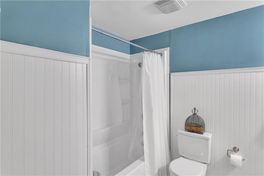 645 Blue Ridge Road Pittsburgh, PA 15239 - Photo 10 of 27 a bathroom with a shower curtain and a toilet