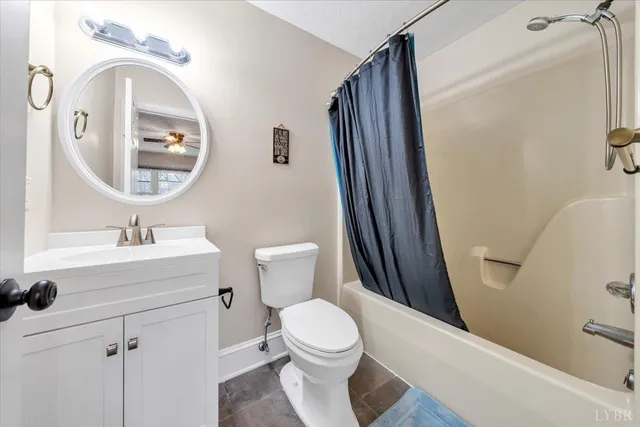 a spacious bathroom with a granite countertop sink mirror and a toilet